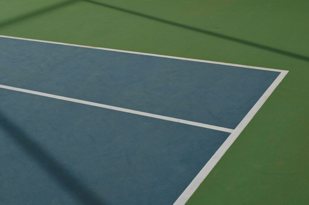 Close up of temporary pickleball lines on a tennis court